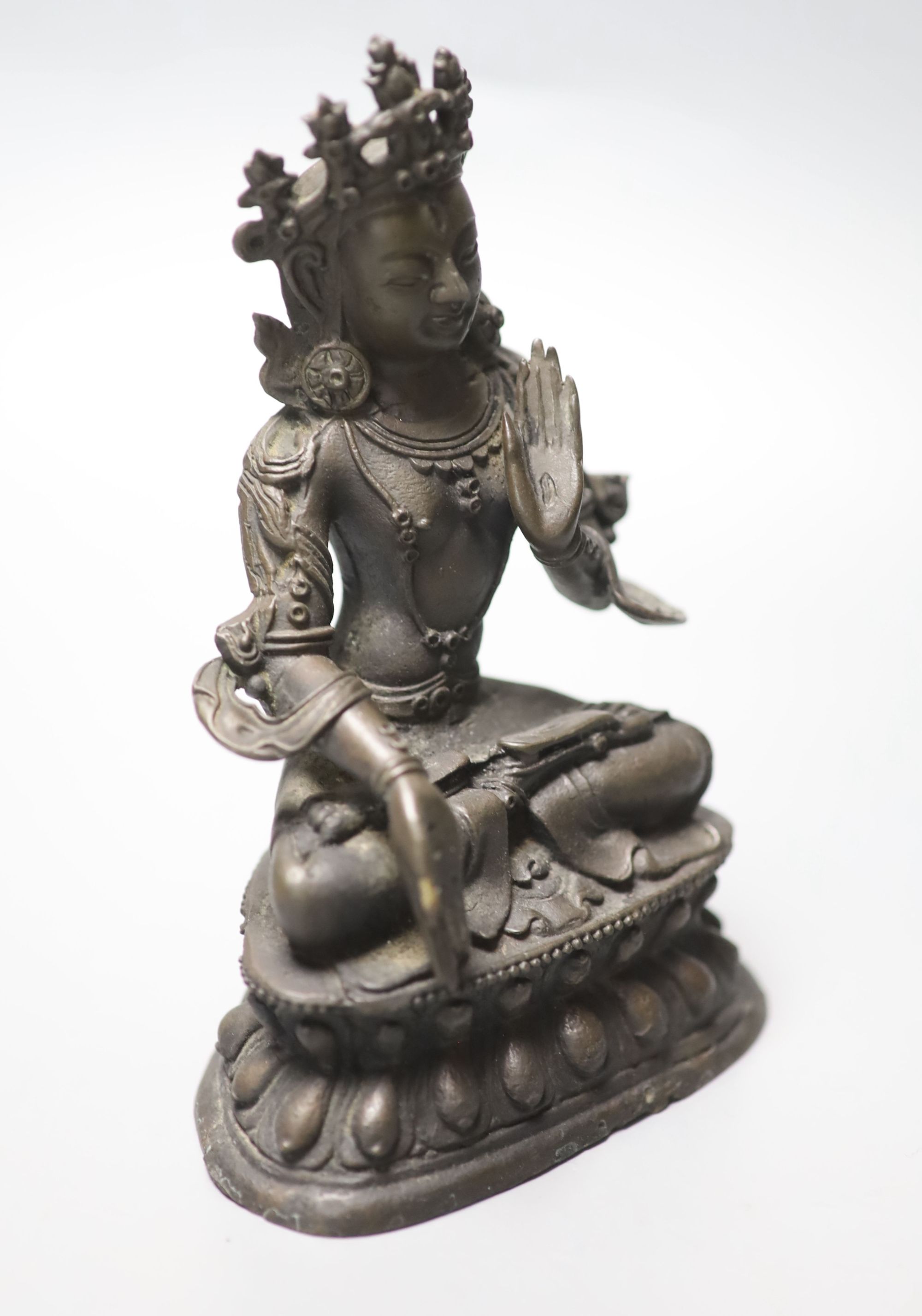 A Chinese or Sino-Tibetan bronze seated Buddha, possibly 18th century, height 16.5cm